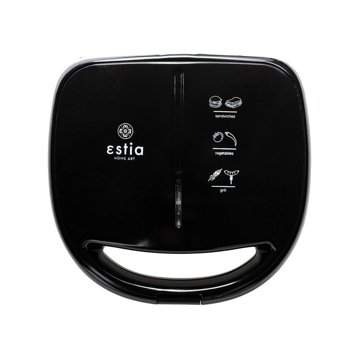 Μαύρη τοστιέρα Estia Basics Black & Inox κλειστή, με ανοξείδωτη πρόσοψη και ενδεικτική λυχνία λειτουργίας, σε λευκό φόντο.