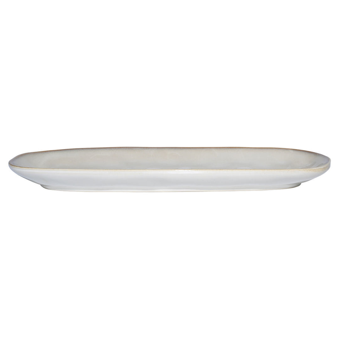Πλαϊνή όψη οβάλ πιατέλας stoneware σε ivory χρώμα, που αναδεικνύει το χαμηλό της ύψος και το κομψό τελείωμα.