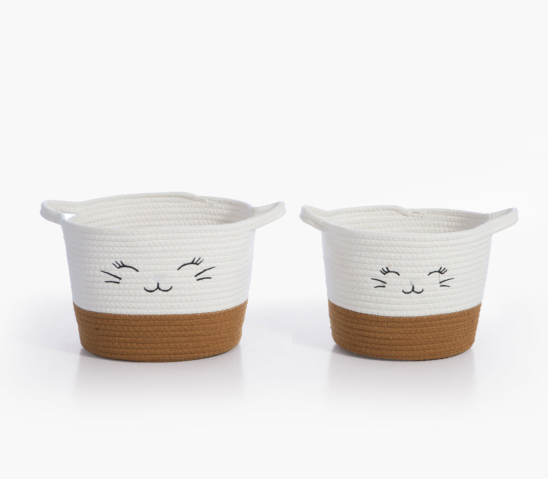 Δύο καλάθια αποθήκευσης Hilda της Nef-Nef Homeware από βαμβακερό σχοινί με χαμογελαστό σχέδιο σε μπεζ και λευκό.