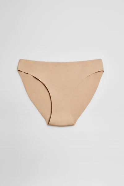 Μπεζ εσώρουχο bikini με αόρατες ραφές, απλωμένο σε λευκό φόντο.