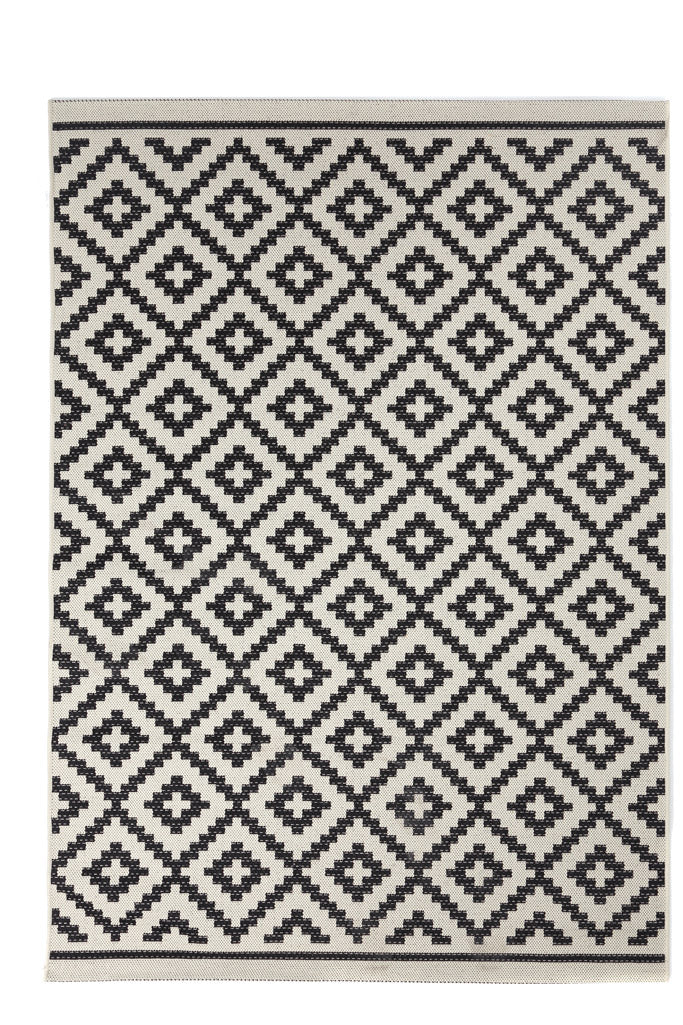 Ασπρόμαυρο ψάθινο χαλί Flox Royal Carpet με γεωμετρικά μοτίβα σε λευκό φόντο και minimal αισθητική.