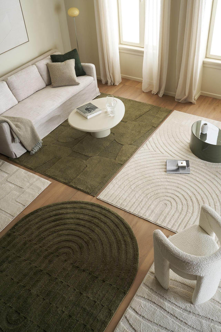 Οβάλ χαλί Jazz της Royal Carpet σε λαδί, τοποθετημένο σε διαμορφωμένο χώρο, με προσεγμένο σχέδιο της σειράς και εμφανή υφή επιφάνειας.